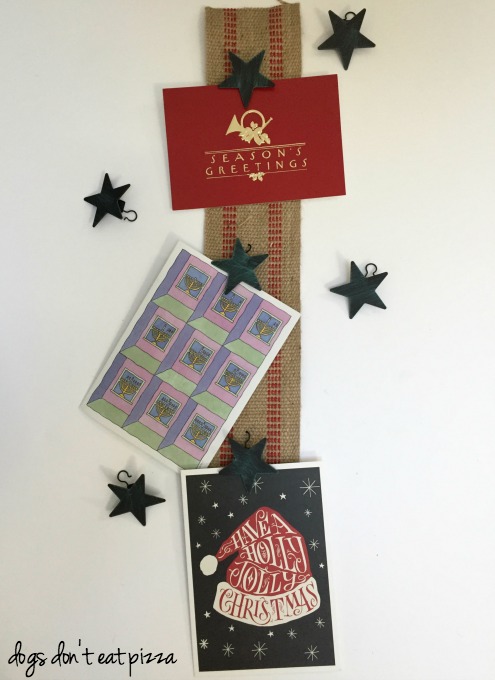 Holiday card holder from webbing and curtain clips - thediybungalow.com