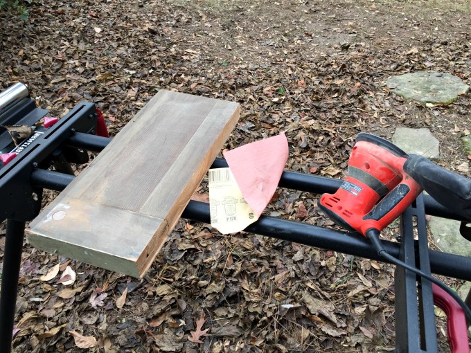 Sanding old door down - how to make reclaimed wood shelves - thediybungalow.com