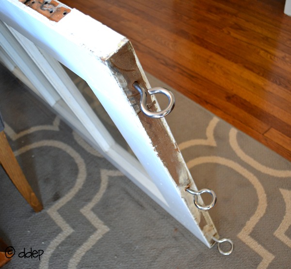 Install eyebolts at top of door - How to Turn a Door into a Sliding Door - thediybungalow.com