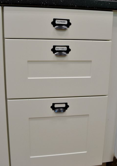 Labeling the new cabinet drawers for the teachers' lounge renovation - thediybungalow.com