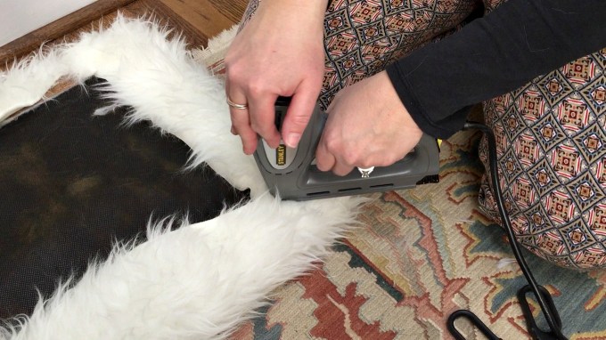 Staple to complete corner of DIY faux fur foot stool - thediybungalow.com