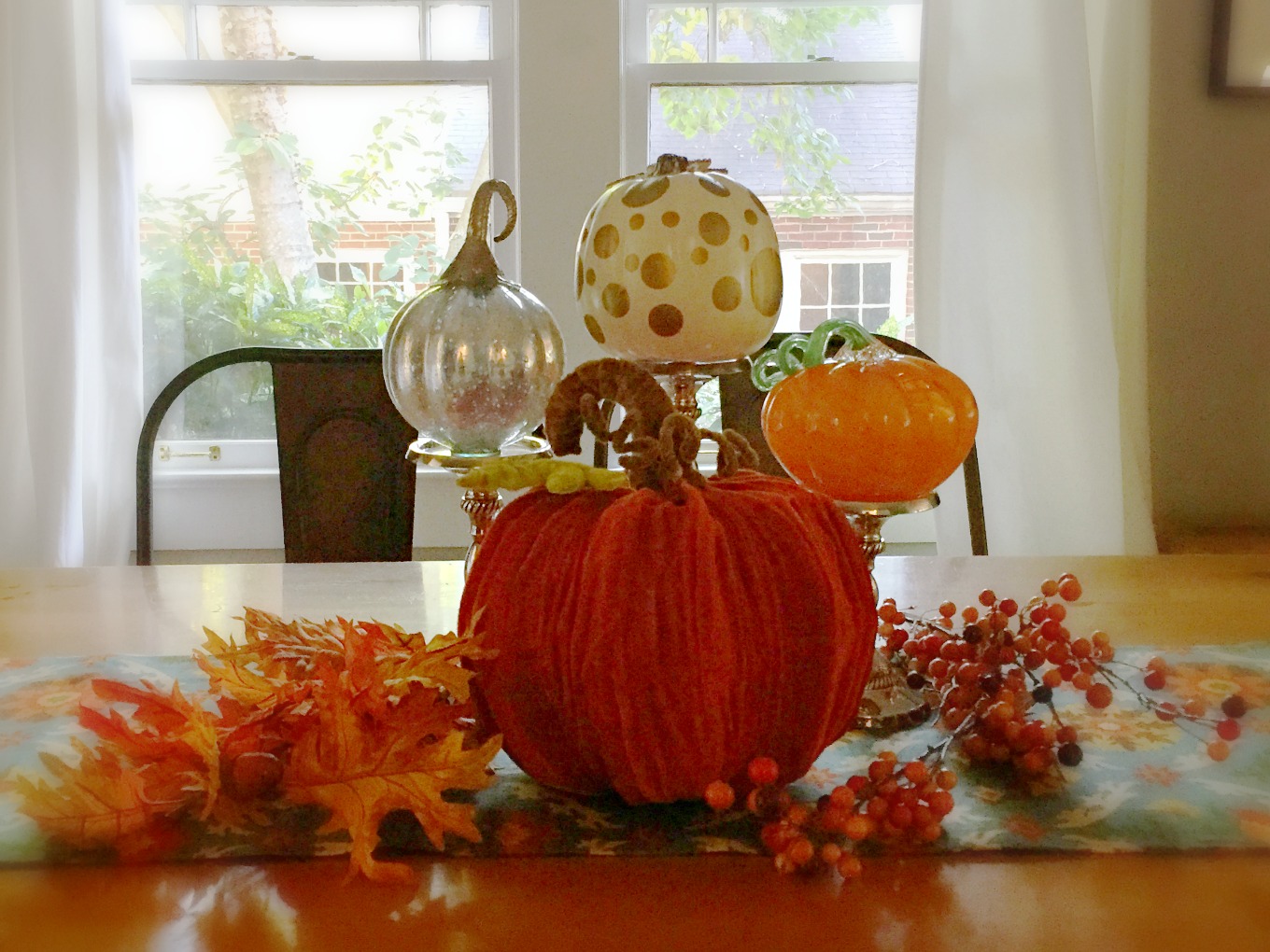Easy fall centerpiece with leaves pumpkins and candlesticks - thediybungalow.com