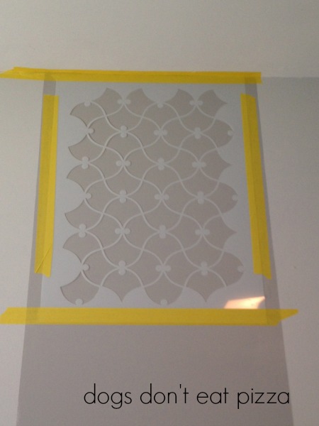 Tape the stencil to the wall with delicate-use painters tape to keep in place - thediybungalow.com