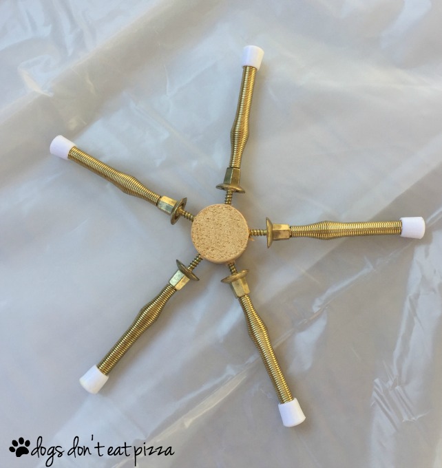 Snowflake from door stops and wood dowels turn hardware into holiday decor - thediybungalow.com