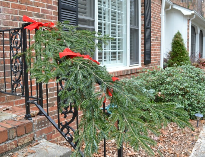 Easy and free holiday garland looks festive on stair railings - thediybungalow.com