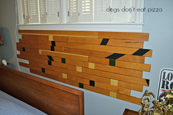 Old gym floor nailed up on the wall for DIY headboard - thediybungalow.com