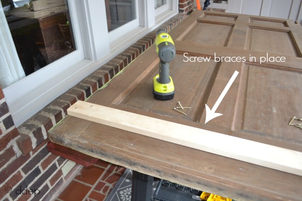 screw braces in place - how to build a daybed from old doors - thediybungalow.com