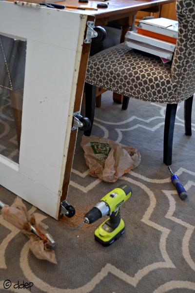 Add casters to bottom of door - How to Turn a Door into a Sliding Door - thediybungalow.com