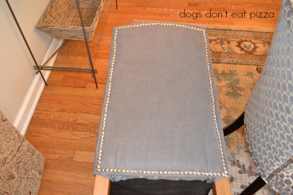 Apply the nailhead trim around the edge and over the staples - how to reupholster parsons chairs - thediybungalow.com