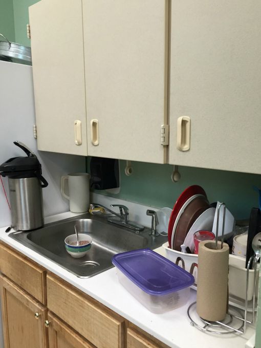 Before the teachers' lounge renovation there were old and mismatched cabinets - thediybungalow.com