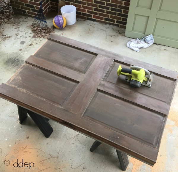 cut down door with circular saw - how to build a daybed from old doors - thediybungalow.com