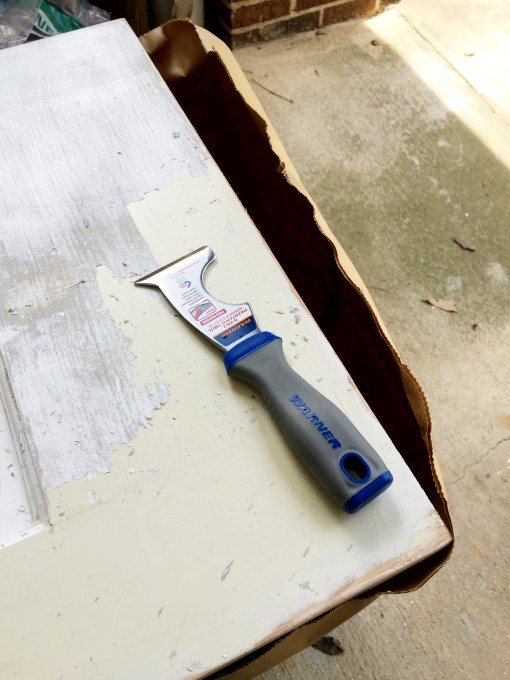 Use 5 in 1 tool to remove paint once the stripper loosens it to strip paint off wood doors - thediybungalow.com