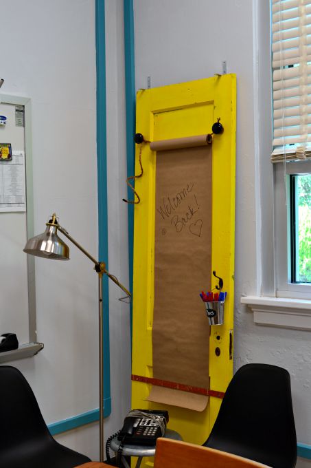 Old door turned into memo center in the teachers' lounge renovation - thediybungalow.com