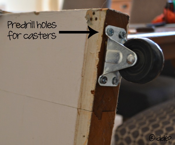 Predrill holes for casters on bottom of door - How to Turn a Door into a Sliding Door - thediybungalow.com