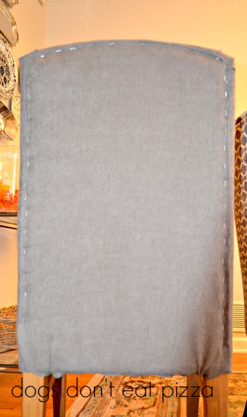 What it should look like after stapling the fabric - how to reupholster parsons chairs - thediybungalow.com