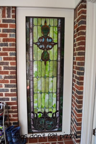 Stained glass window on front porch outside living room in 1929 House - thediybungalow.com