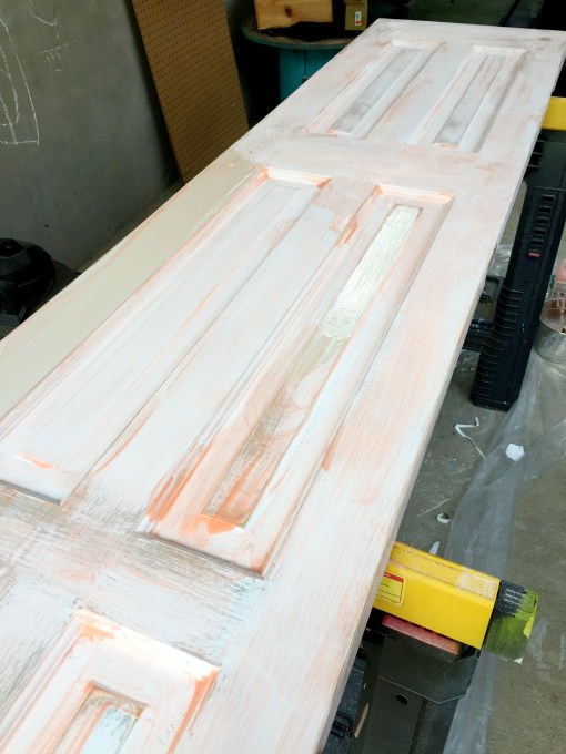 Apply the chemical stripper with a paint brush to strip paint off wood doors - thediybungalow.com