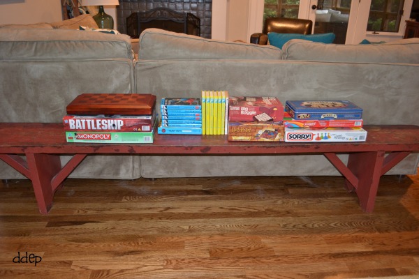 Red bench with games and books in the family room - thediybungalow.com