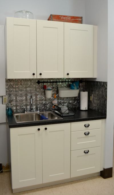 Cabinets that are new and match and provide great storage in the teachers' lounge renovation - thediybungalow.com