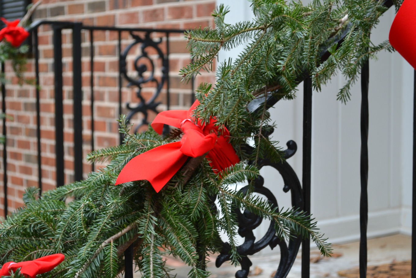 Attach pine branches to railing with ribbon to create an easy free holiday garland - thediybungalow.com