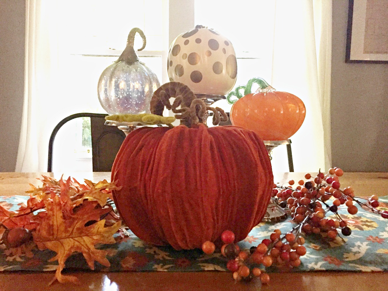 Easy fall centerpiece with pumpkins, candlesticks, and leaves - thediybungalow.com