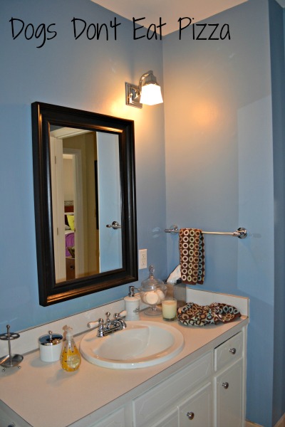 Vanity and mirror in the downstairs bathroom before - thediybungalow.com