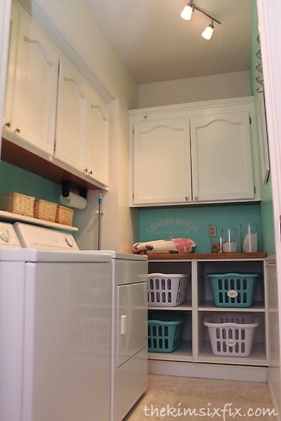 Laundry room makeover from The Kim Six Fix with laundry sorters - thediybungalow.com