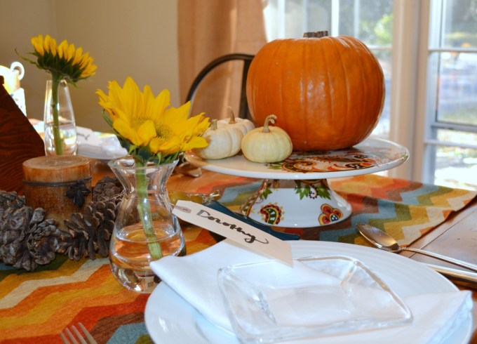 Arranging pumpkins on a colorful cake plate is an easy way to bring natural elements to your Thanksgiving table - thediybungalow.com