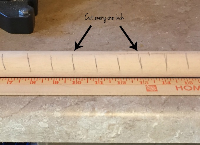 Cutting the dowel for the center of the snowflake to turn hardware into holiday decor - thediybungalow.com