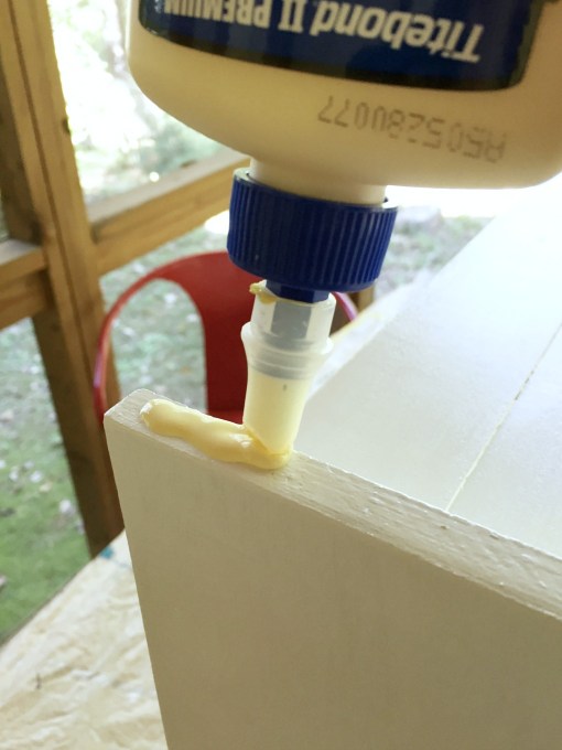 Apply wood glue to attach the base to the drawer turned into a cabinet - thediybungalow.com